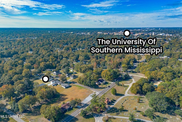 drone / aerial view featuring a forest view