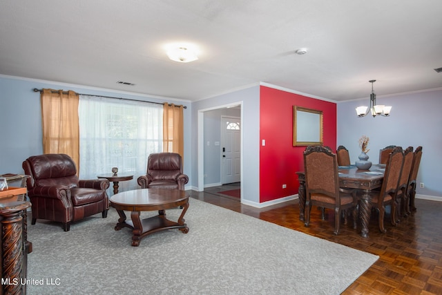 living area featuring a notable chandelier, visible vents, baseboards, and ornamental molding