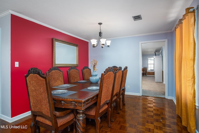 dining room featuring visible vents, baseboards, a chandelier, and ornamental molding