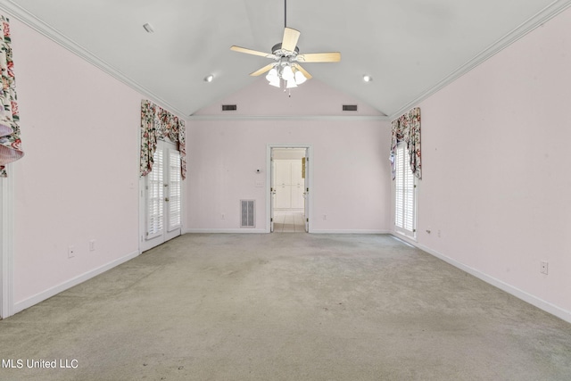 carpeted empty room with french doors, ceiling fan, ornamental molding, and lofted ceiling