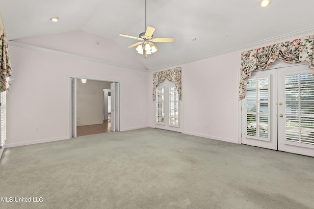 carpeted empty room with ornamental molding, lofted ceiling, french doors, and ceiling fan