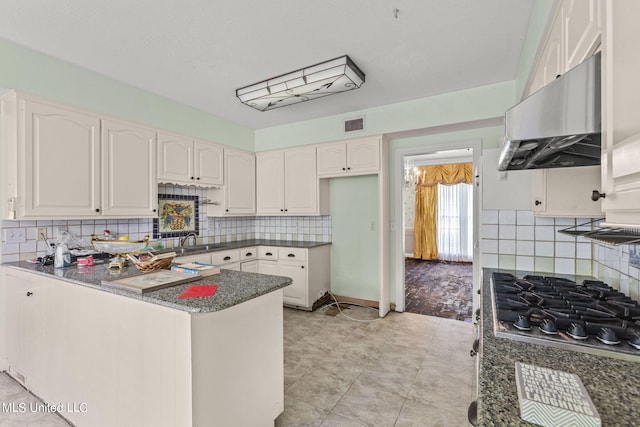 kitchen featuring white cabinetry and tasteful backsplash