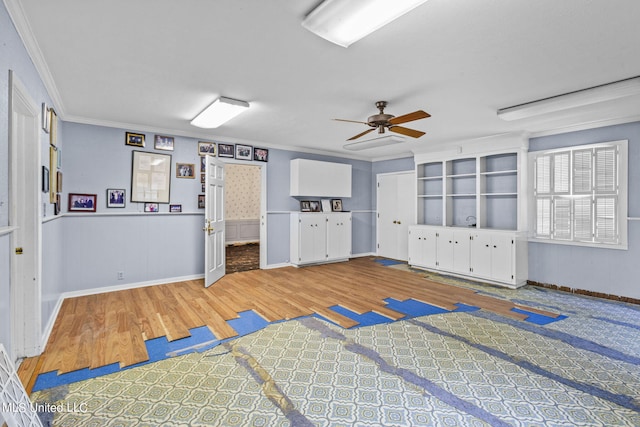 interior space with hardwood / wood-style floors, crown molding, and ceiling fan