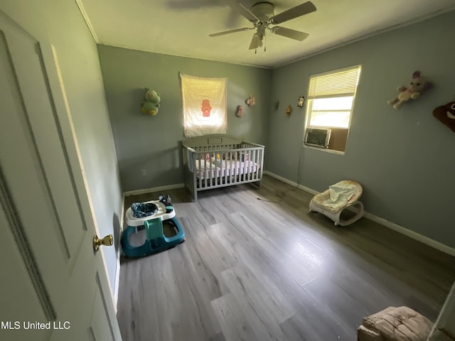 260 SCR 62, Magee, MS 39111 - bedroom with a crib, wood finished floors, baseboards, and crown molding