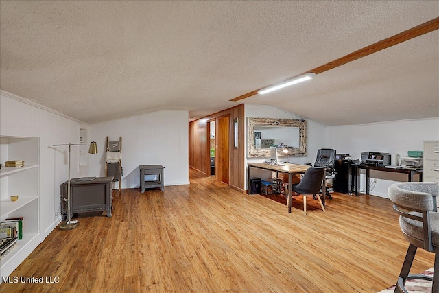 home office with ornamental molding, a textured ceiling, light wood-type flooring, and vaulted ceiling