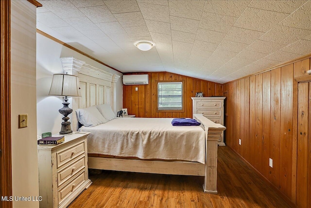 bedroom with lofted ceiling, a wall mounted AC, ornamental molding, wood walls, and dark hardwood / wood-style floors