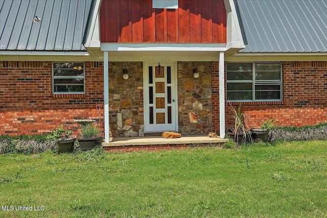 property entrance with a lawn