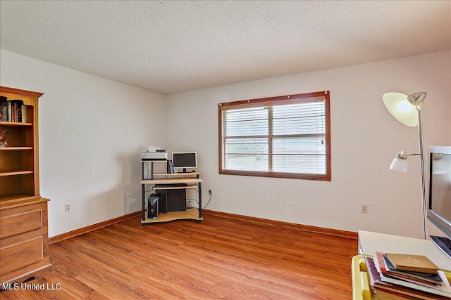 home office featuring hardwood / wood-style floors and a textured ceiling