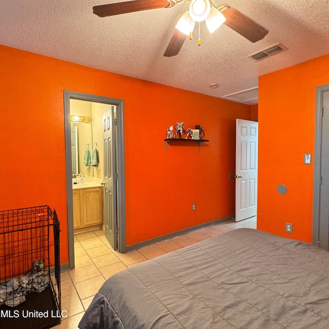 tiled bedroom featuring ensuite bath, ceiling fan, and a textured ceiling