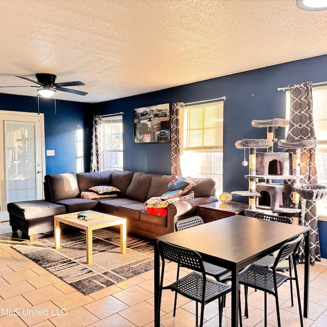 tiled living room with a textured ceiling and ceiling fan