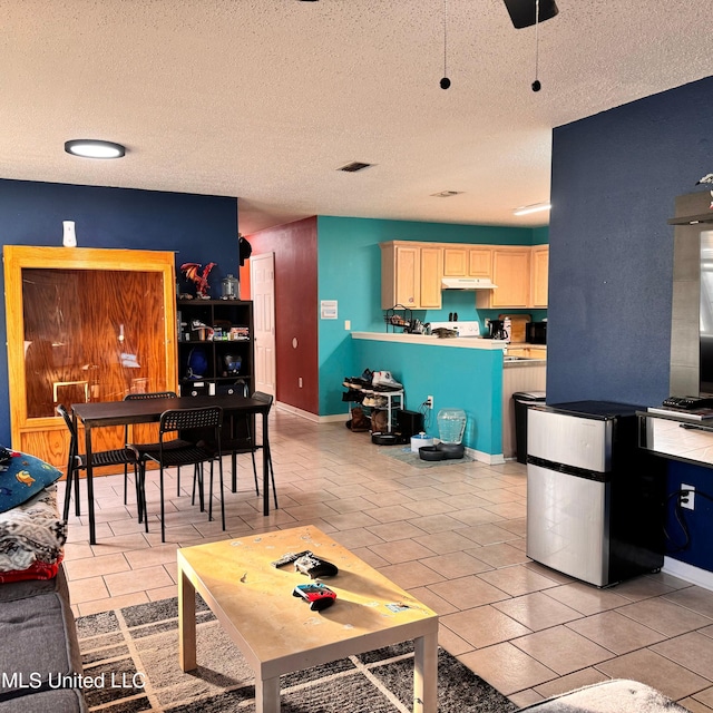 tiled living room with a textured ceiling