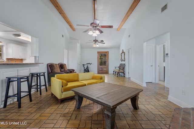 living room with ceiling fan, beam ceiling, and high vaulted ceiling