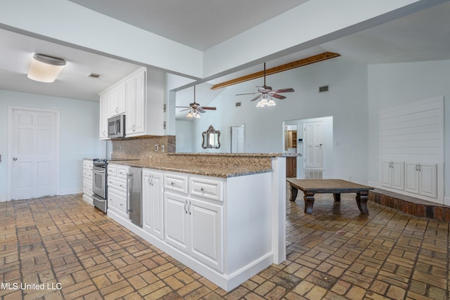 kitchen with tasteful backsplash, white cabinetry, light stone counters, kitchen peninsula, and stainless steel appliances