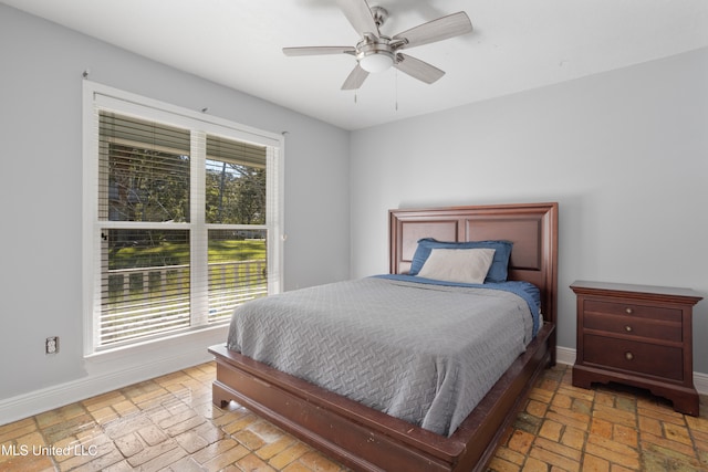 bedroom with multiple windows and ceiling fan