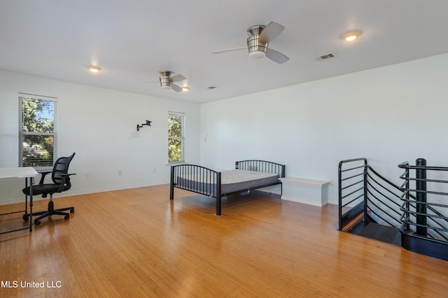 bedroom featuring multiple windows and light hardwood / wood-style flooring