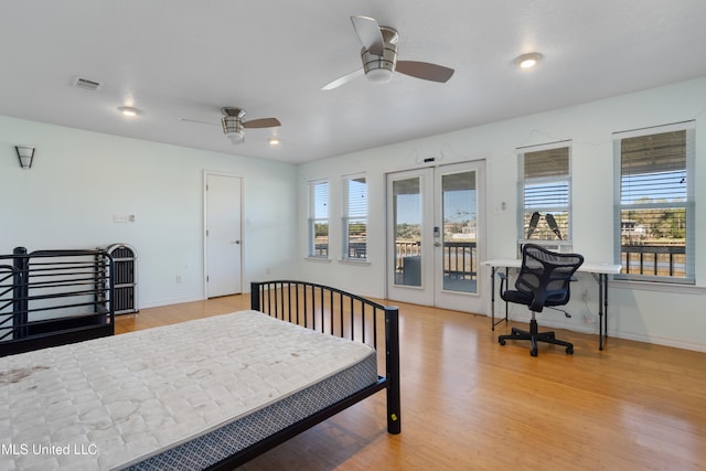 bedroom with french doors, light wood-type flooring, multiple windows, and ceiling fan