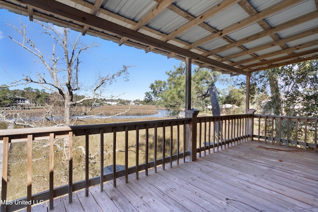 wooden terrace featuring a water view