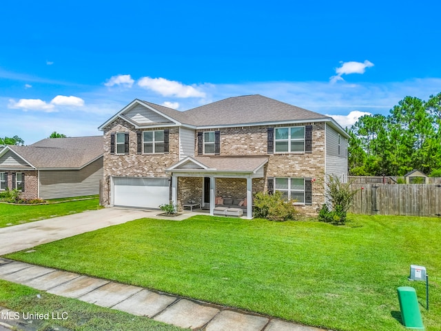 view of front of home with a garage and a front lawn