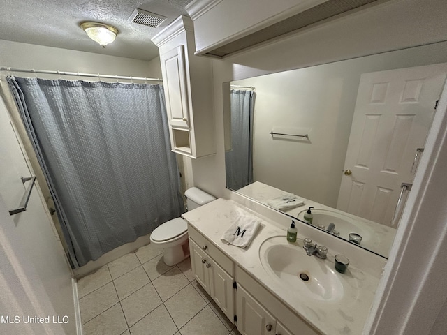 bathroom featuring vanity, a shower with curtain, tile patterned flooring, toilet, and a textured ceiling