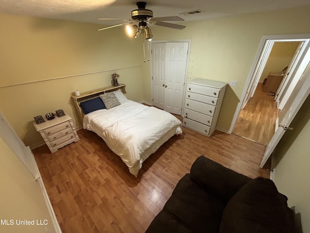 bedroom with a closet, ceiling fan, and light hardwood / wood-style flooring