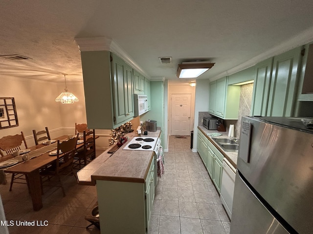 kitchen featuring a kitchen breakfast bar, green cabinets, a chandelier, and appliances with stainless steel finishes