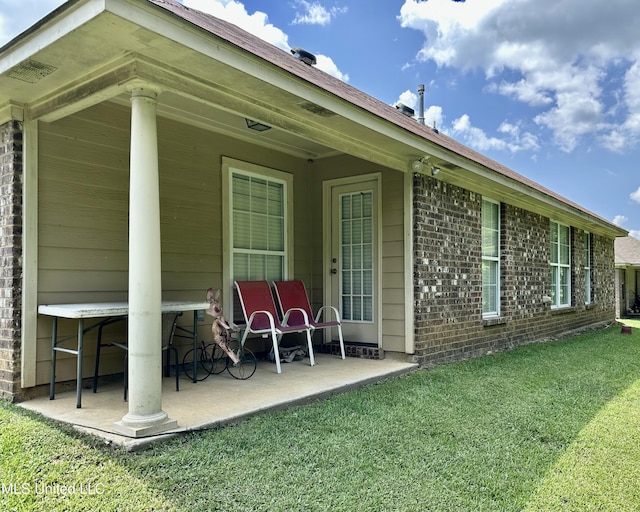 235 Gaddy Dr, Byram, MS 39272 - rear view of house with a yard, brick siding, and a patio