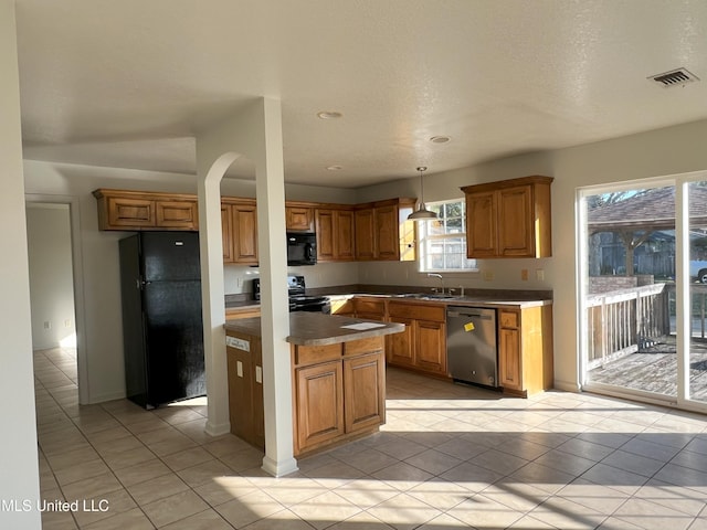 kitchen featuring pendant lighting, sink, light tile patterned floors, and black appliances