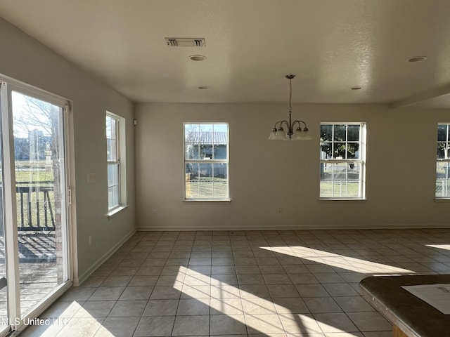 unfurnished dining area with tile patterned floors and a notable chandelier