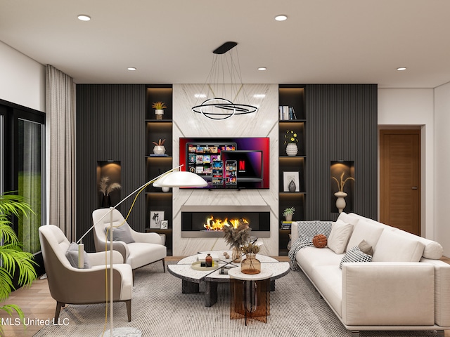 living room featuring built in features, a premium fireplace, and wood-type flooring