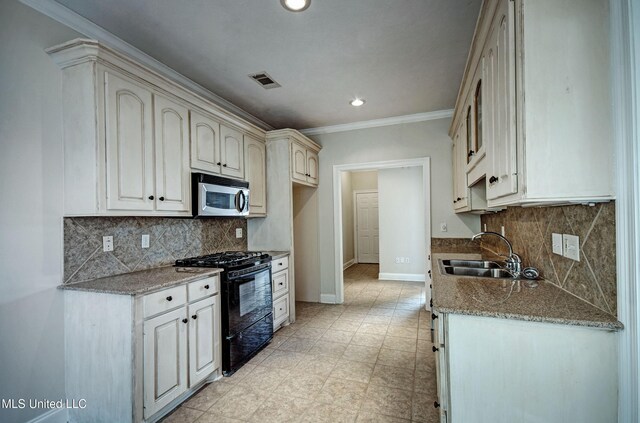 508 Jasmine Ct, Brandon, MS 39047 - kitchen featuring a sink, stainless steel microwave, visible vents, black gas range, and baseboards