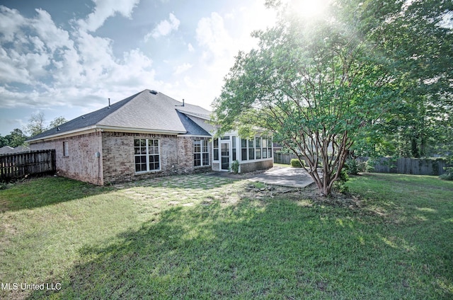 508 Jasmine Ct, Brandon, MS 39047 - rear view of house with a sunroom, a patio, and a fenced backyard
