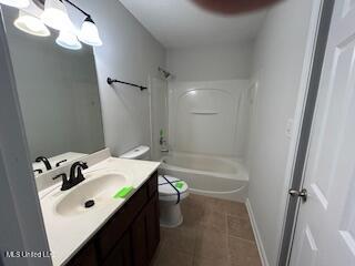 134 Shadow Ln, Batesville, MS 38606 - bathroom featuring toilet, tile patterned flooring, vanity, and tub / shower combination