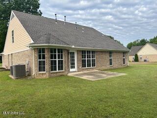 134 Shadow Ln, Batesville, MS 38606 - rear view of property with a patio, a yard, and central AC