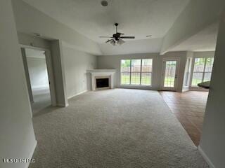 134 Shadow Ln, Batesville, MS 38606 - unfurnished living room with carpet flooring, ceiling fan, lofted ceiling, a fireplace, and baseboards