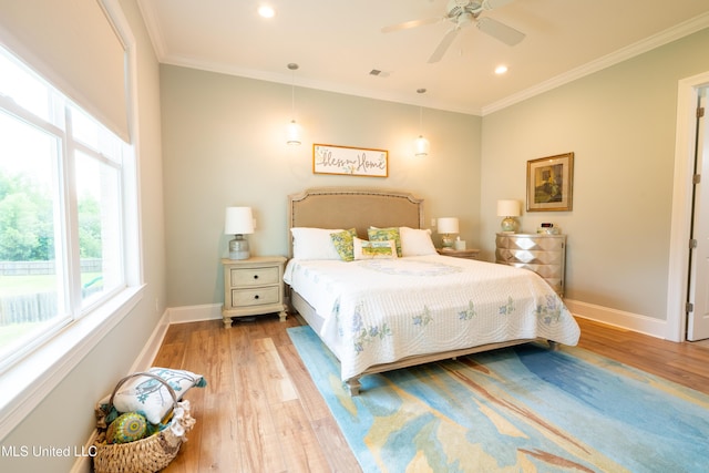 bedroom featuring baseboards, crown molding, and wood finished floors