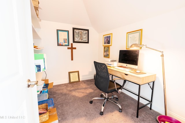 carpeted office space with lofted ceiling and baseboards