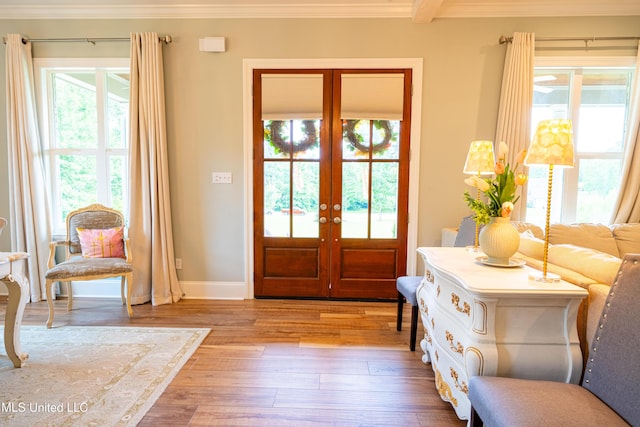 doorway to outside featuring baseboards, french doors, hardwood / wood-style flooring, and crown molding