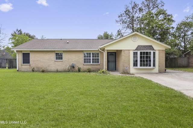 12509 Ponce De Leon Dr, Ocean Springs, MS 39564 - ranch-style home with roof with shingles, fence, a front lawn, and brick siding