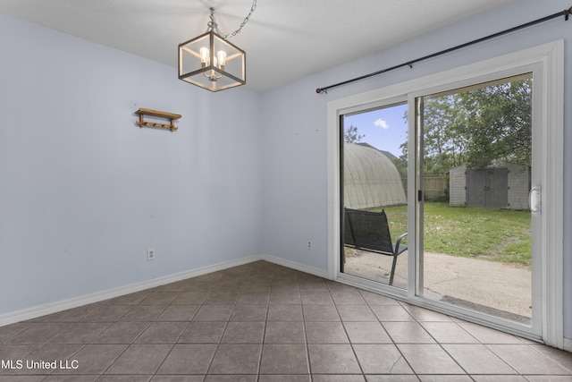 12509 Ponce De Leon Dr, Ocean Springs, MS 39564 - spare room featuring baseboards, a notable chandelier, a healthy amount of sunlight, and tile patterned floors