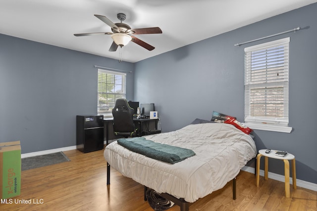 12509 Ponce De Leon Dr, Ocean Springs, MS 39564 - bedroom featuring baseboards, a ceiling fan, and wood finished floors