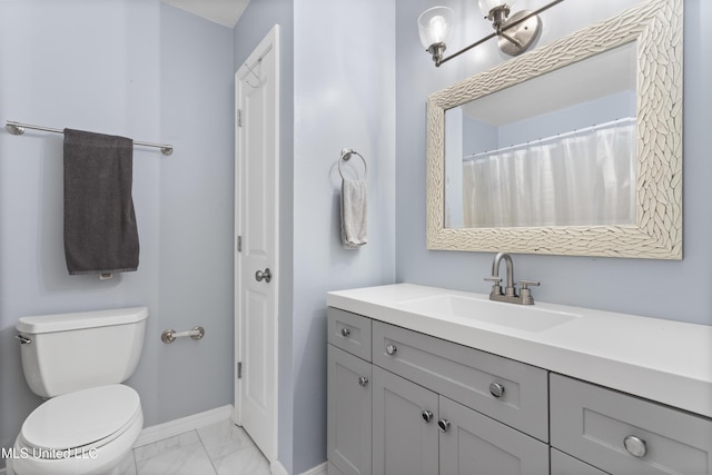 12509 Ponce De Leon Dr, Ocean Springs, MS 39564 - full bathroom featuring baseboards, marble finish floor, vanity, and toilet