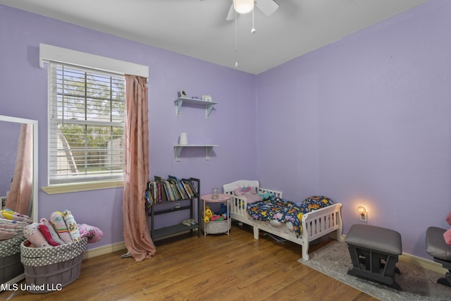 12509 Ponce De Leon Dr, Ocean Springs, MS 39564 - bedroom with baseboards, a ceiling fan, and wood finished floors