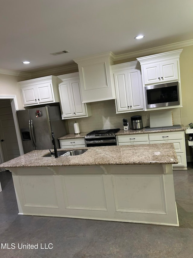 kitchen with a center island with sink, sink, appliances with stainless steel finishes, tasteful backsplash, and crown molding