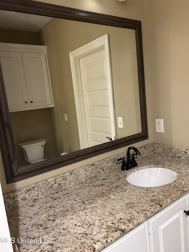 bathroom with vanity and toilet