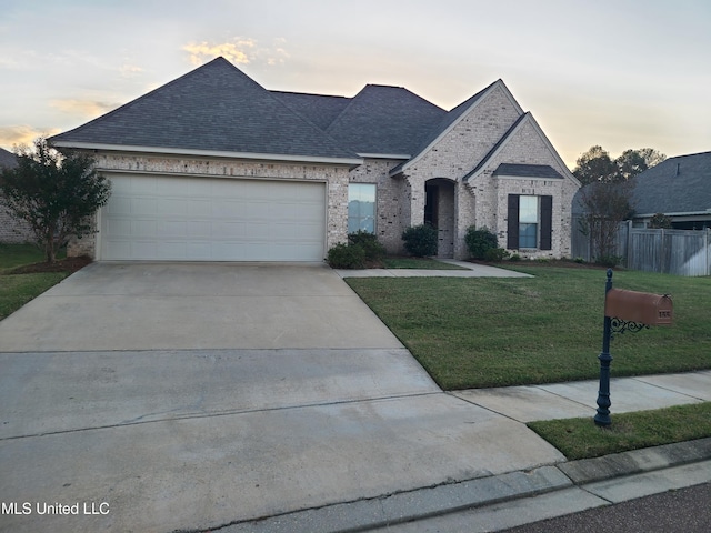 view of front of home featuring a lawn and a garage