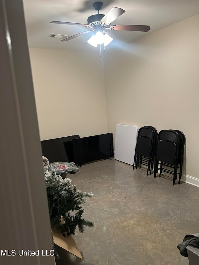 misc room with concrete flooring and ceiling fan