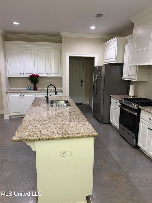 kitchen featuring appliances with stainless steel finishes, sink, a center island with sink, and white cabinets