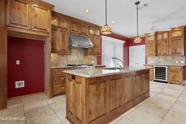 1529 Magnolia St Unit 15, Gulfport, MS 39507 - kitchen with range hood, wine cooler, a sink, light tile patterned flooring, and decorative backsplash