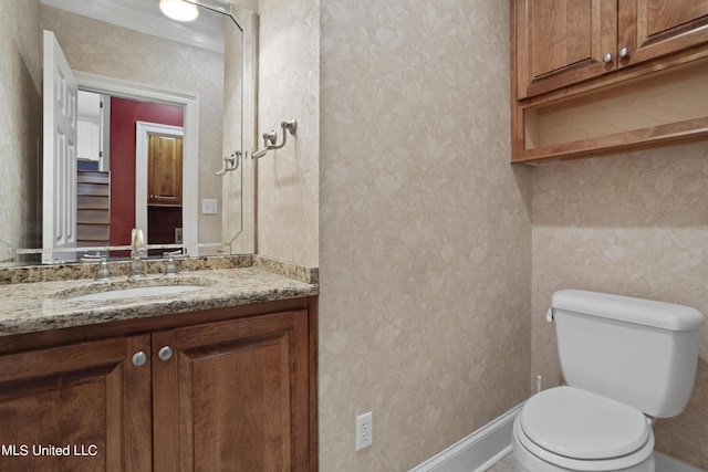 1529 Magnolia St Unit 15, Gulfport, MS 39507 - half bathroom featuring vanity, toilet, crown molding, wallpapered walls, and baseboards