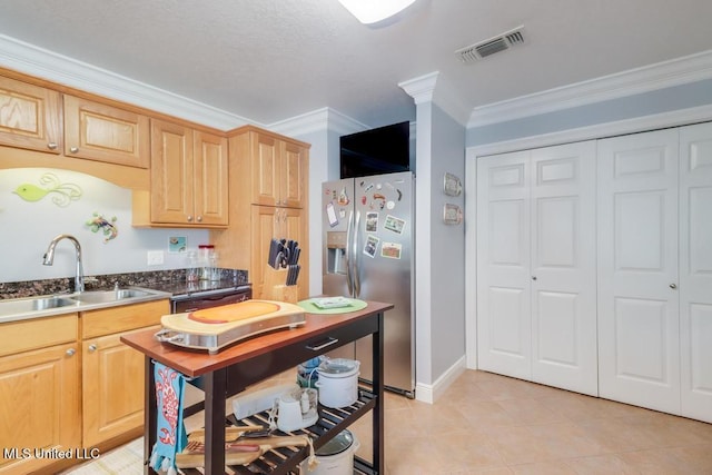 kitchen with light tile patterned flooring, light brown cabinetry, sink, crown molding, and stainless steel fridge with ice dispenser